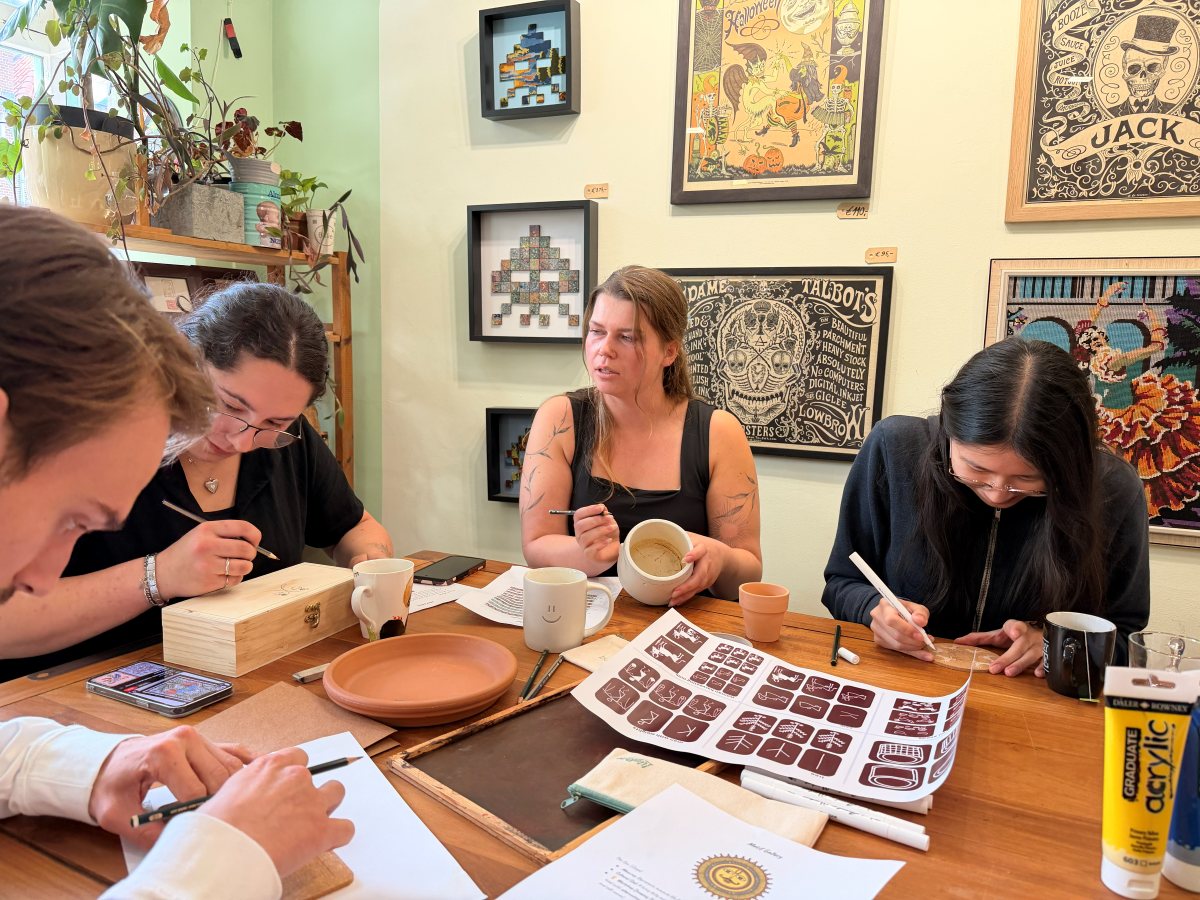 Participants painting around the studio table