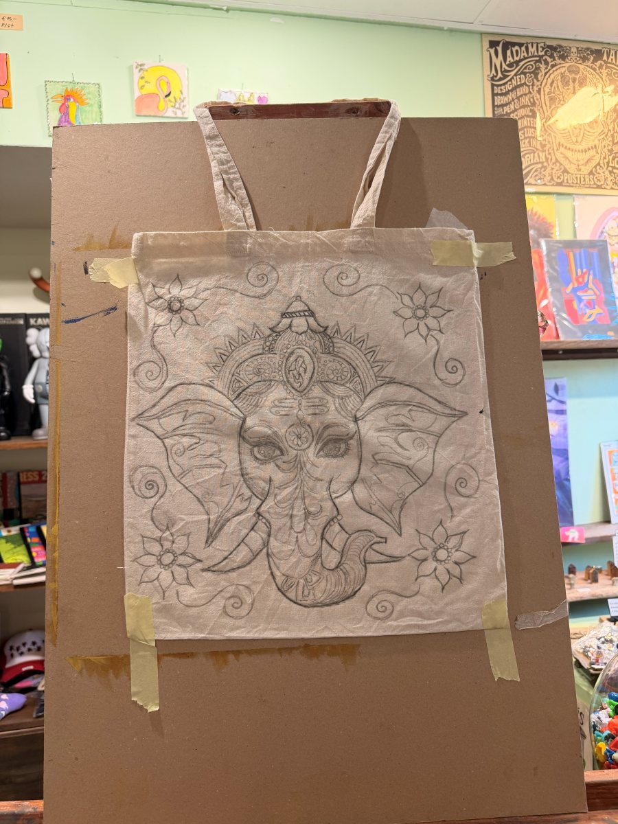A Ganesha design sketched onto a tote bag in progress