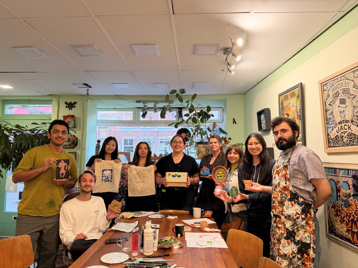 The whole group holding up their finished pieces
